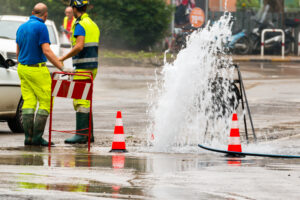Workers fixing water leak in road